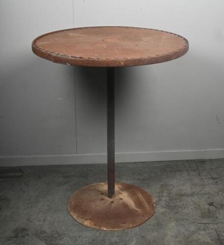 TABLE: A large standing rustic table with saw blade top, mounted to circular base. 90cm tall.