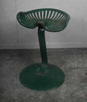 SEAT: A vintage tractor seat mounted to circular cast base, approx 60cm tall, seat unmarked.