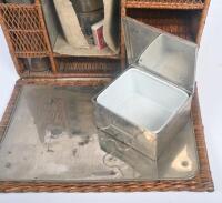 TEA BASKET: An early travel tea hamper set, within fold out cane basket, includes lamp and kettle, two cups with glass bottle, two drawers with porcelain inserts and cutlery.&nbsp; - 4