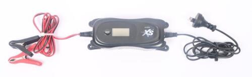 BATTERY CHARGER: An XS auto car battery charger for 6v & 12v lead acid batteries. Plugged in and screen lights up