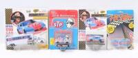 RICHARD PETTY #43: Set of 4 Richard Petty #43 NASCAR collectibles, 3 1:64 scale stock cars, and 1 1:87 scale official team transporter truck and trailer, all plastic display wrapped.