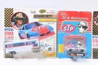 RICHARD PETTY #43: Set of 4 Richard Petty #43 NASCAR collectibles, 3 1:64 scale stock cars, and 1 1:87 scale official team transporter truck and trailer, all plastic display wrapped. - 2