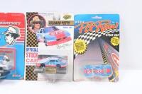 RICHARD PETTY #43: Set of 4 Richard Petty #43 NASCAR collectibles, 3 1:64 scale stock cars, and 1 1:87 scale official team transporter truck and trailer, all plastic display wrapped. - 3