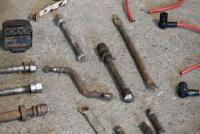 NORTON: Quantity&nbsp;of&nbsp;miscellaneous&nbsp;motorcycle parts, believed to Norton, circa 1940's-1950s', including rear wheel bolts (x9), assorted levers (x3), 1 handlebar clamp, 4 high tension leads, 3 brake anchors, front mud guard brackets, pair of headlamp mounts - 3