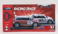 SLOT CAR RACING SET: 1:64 scale JToys racing track set, including tracks, hand throttle controls with connections, crash barriers, and 2 racing Minis, 1 Blue with Silver striping, and 1 Red with White striping and Black and White chequered roof, custom bo