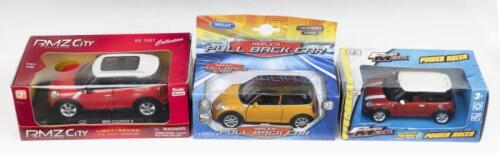 343 · MINI: Set of 3 powered Minis, 1 1:24 scale RMZ City Die Cast Collection Red and White Mini Cooper with lights and sound, 1 1:36 scale Welly Mustard and Black pull back Mini, and 1 1:43 Maisto Fresh Metal Red and White pull back Mini, all custom display boxed.