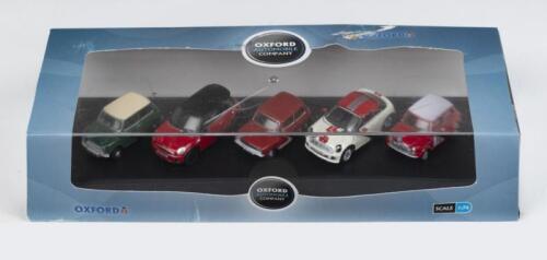 368 · OXFORD AUTOMOBIILE COMPANY: Set of 5 1:76 Oxford Minis, 1 Mini Cooper S Mk.II in Monte Carlo Rally 1968 livery in red with white roof and featuring #18 on the side, 1 Mini GT in Reynard Metallic, a red gold with white stripes along the skirt, 1 early Austin Mini Cooper, registered LSL 233 and decorated in Almond Green with Old English White roof, 1 BMW era Mini Cooper S in Chilli Red with black trim registered BG09 WDX, and 1 BMW era Mini Coupe in Pepper White and Chilli Red, all in a custom dis
