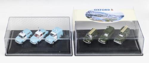 369 · OXFORD DIE-CAST: 2 1:76 scale Oxford Die-Cast sets of 3 models, 1 Olive Green Post Office set (Morris, Mini and Anglia Vans), and 1 Light Blue and White Police set (Morris and Mini Vans, and Anglia Saloon), clear boxed.