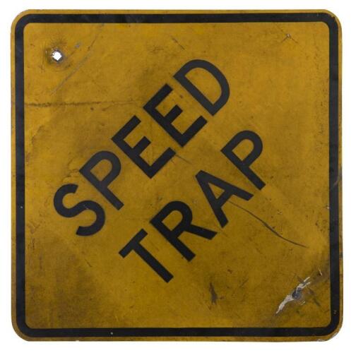 ROAD SIGN: 'Speed Trap', black lettering on yellow road sign