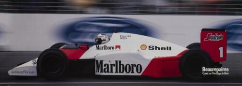 ALAIN PROST: A wide publicity poster published by sponsor depicting Alain Prost driving his McLaren MP/3, 32cm high, 89cm wide