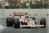 ALAIN PROST: A large photo stock poster depicting Alain Prost driving his McLaren MP4/3, 50cm high, 75cm wide