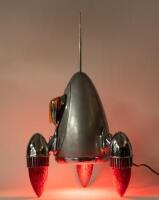 A interesting 'Car Part Art' lamp sculpture&nbsp;in rocket form titled 'Blast Off' by Australian artist Terry Lawrie made from genuine retro car parts&nbsp;including&nbsp;'59 Cadillac taillight lenses and others, approx 66cm high