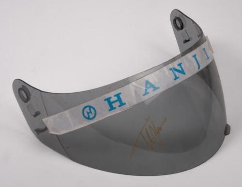 FERNANDO ALONSO: A tinted perspex helmet visor with Hanjin branding sticker and Fernando Alonso signature in gold marker. Visor 26.5cm wide.
