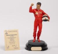 MICHAEL SCHUMACHER: A 1:9 scale limited edition (2435/5000) cold cast porcelain resin figure of Michael Schumacher sculpted by Paul Szeiler for Endurance Ltd, on wooden base with engraved plaque, NIB and accompanied by a COA from The Art of Sport, 22cm hi