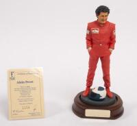 ALAIN PROST: A 1:9 scale limited edition (1154/5000) cold cast porcelain resin figure of Alain Prost&nbsp;sculpted by Paul Szeiler for Endurance Ltd, on wooden base with engraved plaque, NIB and accompanied by a COA from The Art of Sport, 22cm high