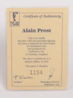 ALAIN PROST: A 1:9 scale limited edition (1154/5000) cold cast porcelain resin figure of Alain Prost&nbsp;sculpted by Paul Szeiler for Endurance Ltd, on wooden base with engraved plaque, NIB and accompanied by a COA from The Art of Sport, 22cm high - 4