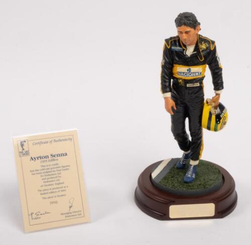AYRTON SENNA: A 1:9 scale limited edition (3950/5000) cold cast porcelain resin figure of Ayrton Senna sculpted by Paul Szeiler for Endurance Ltd, on wooden base with engraved plaque, NIB and accompanied by a COA from The Art of Sport, 22cm high