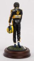 AYRTON SENNA: A 1:9 scale limited edition (3950/5000) cold cast porcelain resin figure of Ayrton Senna sculpted by Paul Szeiler for Endurance Ltd, on wooden base with engraved plaque, NIB and accompanied by a COA from The Art of Sport, 22cm high - 3