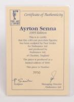 AYRTON SENNA: A 1:9 scale limited edition (3950/5000) cold cast porcelain resin figure of Ayrton Senna sculpted by Paul Szeiler for Endurance Ltd, on wooden base with engraved plaque, NIB and accompanied by a COA from The Art of Sport, 22cm high - 4