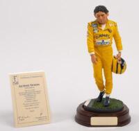AYRTON SENNA: A 1:9 scale limited edition (3949/5000) cold cast porcelain resin figure of Ayrton Senna&nbsp;sculpted by Paul Szeiler for Endurance Ltd, on wooden base with engraved plaque, NIB and accompanied by a COA from The Art of Sport, 22cm high