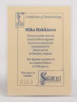 MIKA HAKKINEN: A 1:9 scale limited edition (0563/5000) cold cast porcelain resin figure of Mika Hakkinen&nbsp;sculpted by Paul Szeiler for Endurance Ltd, on wooden base with engraved plaque, NIB and accompanied by a COA from The Art of Sport, 22cm high - 4