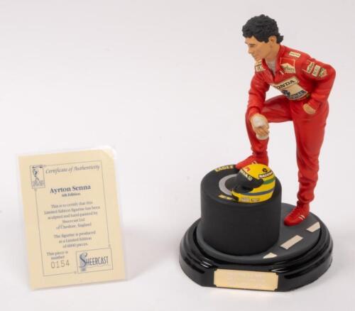 AYRTON SENNA: A 1:9 scale limited edition (0154/5000) cold cast porcelain resin figure of Ayrton Senna sculpted by Paul Szeiler for Endurance Ltd, on wooden base with engraved plaque, NIB and accompanied by a COA from The Art of Sport, 22cm high