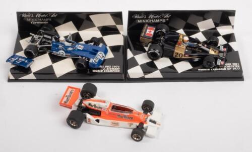 McLAREN TYRRELL WOLF: A group lot of formula 1 race cars, a McLaren M26, number 1 as driven by James Hunt in 1977, manufactured by Eidaico models, a Tyrrell 003, number 12 as driven by Jackie Stewart in 1971, manufactured by Minichamps, and a Wolf Ford WR1, number 20 as driven by Jody Scheckter