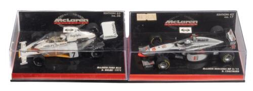 McLAREN M23 MP 4/12: A pair of McLaren formula 1 models, an Ford M23, the number 7 car as driven by Denny Hulme in 1973, manufactured by Minichamps, product number 530 734307, also a Mercedes MP 4/12, the number 10 car as driven by David Coulthard in 1997, manufactured by Minichamps, product number 530 974310