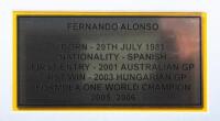 ALONSO: A box&nbsp;framed collage relating to F1 World Champion Driver Fernando Alonso, including Puma 'ING' racing glove with Fernando Alonso signature surrounded by four photographs and plaque. Measures 84cm wide, 59cm high. - 3