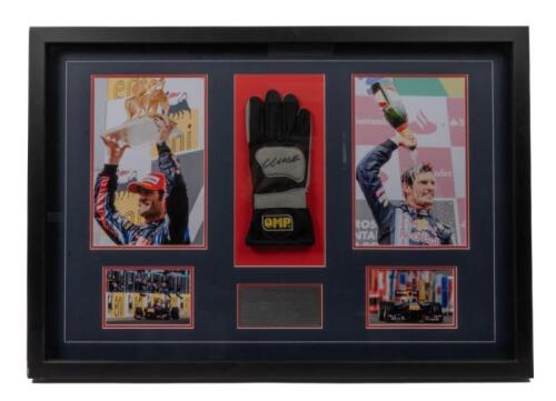 WEBBER: A box framed & collage relating to successful F1 driver Mark Webber, including OMP racing glove with Mark Webber signature surrounded by four photographs and plaque. Measures 84.5cm wide, 59cm high.