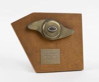 TROPHY: A Vintage Sports Car Club of Australia 'Vickery Trophy' as awarded to Robert King for equal second in 1975. Brass spinner form mounted to wood. 18.5cm wide, 15cm high.