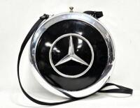A decorative lined ladies handbag constructed from two Mercedes-Benz hubcaps, 25cm diameter, by automotive artist Terry Lawrie