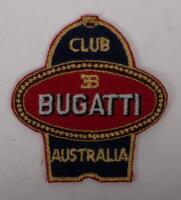 BUGATTI AUSTRALIA: A collection of items mostly relating to the Bugatti Club of Australia, a performance trophy from the 2016 event in Mansfield, mounted on wooden base, a Bugatti Club of Australia cloth patch and small pin and also replica pin bearing 'E - 2