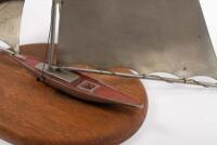 YACHT: A decorative 1950s metal yacht sculpture in full sail on a wooden base, some wiring detached, 37cm high, 38cm wide - 2