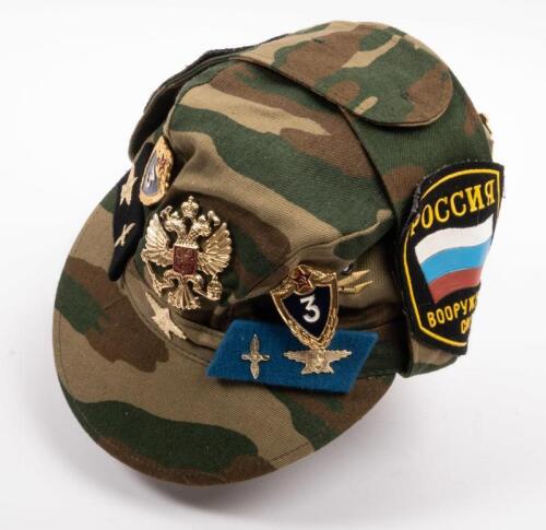 USSR: A Soviet Military styled hat with patches either side of the hat and various pins.