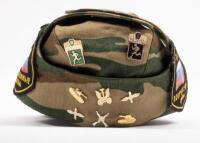 USSR: A Soviet Military styled hat with patches either side of the hat and various pins. - 2