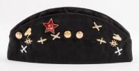 USSR: A Soviet Military styled Garrison hat, Black. Fitted with various Soviet era pins.