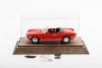 ALFA ROMEO: A circa 1982 Togi 1:23 scale 1955 Alfa Romeo Giulietta Spider 1300 (#15), in perspex case, model is loose on base also has some loose parts