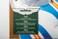 ASTON MARTIN RACING: Two Aston Martin laminated racing posters. '25 YEARS ON - Aston Martin is back! 1959-1984' & 1989 ASTON MARTIN racing poster by John Evans - 7