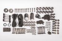 DB6: A collection of Aston Martin DB6 parts including a new pair of steering rack mounts, pair of electric cables for Selecta-Ride shock absorbers, as well as selection of used parts such as conrod nuts and bolts, valves, springs, collets, timing chains, 