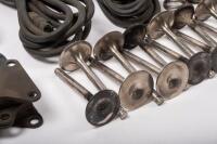DB6: A collection of Aston Martin DB6 parts including a new pair of steering rack mounts, pair of electric cables for Selecta-Ride shock absorbers, as well as selection of used parts such as conrod nuts and bolts, valves, springs, collets, timing chains, - 2
