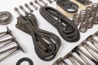 DB6: A collection of Aston Martin DB6 parts including a new pair of steering rack mounts, pair of electric cables for Selecta-Ride shock absorbers, as well as selection of used parts such as conrod nuts and bolts, valves, springs, collets, timing chains, - 9