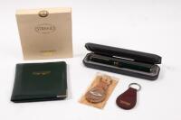 ASTON MARTIN: Four items of Aston Martin paraphernalia. STRAND green handmade leather ASTON MARTIN notecase