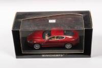 DB9: A diecast&nbsp;1:43&nbsp;scale Minichamps&nbsp;Aston Martin DB9&nbsp;2003&nbsp;red metallic, in original box