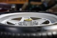 FERRARI 308: An excellent standing table using a c1985 Ferrari 308 '165 TR 390 Speedline SL129' wheel with fitted period Michelin tyre, table complete with glass top, 106cm tall, diameter of glass top 86cm - 9