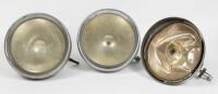 HEADLIGHTS: A pair of Lucas nickel&nbsp;plated brass headlights, stamped model number 'RB76', glass lens 21cm in diameter, also includes third matching light but damaged&nbsp;and no glass lens