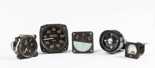 AVIATION GAUGES: A group of five vintage aviation gauges, including an attitude indicator, a voltmeter, an oil pressure gauge (crack in lens), a supercharger boost gauge and a compass.