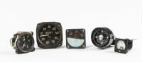 AVIATION GAUGES: A group of five vintage aviation gauges, including&nbsp;an attitude indicator, a voltmeter, an oil pressure gauge (crack in lens), a supercharger boost gauge and a compass.