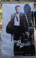 JAMES BOND/CASINO ROYALE: A very large double sided wall banner poster featuring Daniel Craig and an Aston Martin DBS V12 promoting the James Bond&nbsp;film 'Casino Royale', 243cm high, 152cm wide