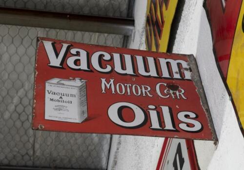 VACUUM: A c1920s-1930s original English double sided 'Vacuum Motor Car Oils' enamel flange sign featuring an excellent pictorial of a 'Vacuum 'A'&nbsp;Mobiloil Gargoyle' tin,&nbsp;40.5cm high, 51cm wide